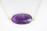 Amethyst stone set in gold bezel with gold chain